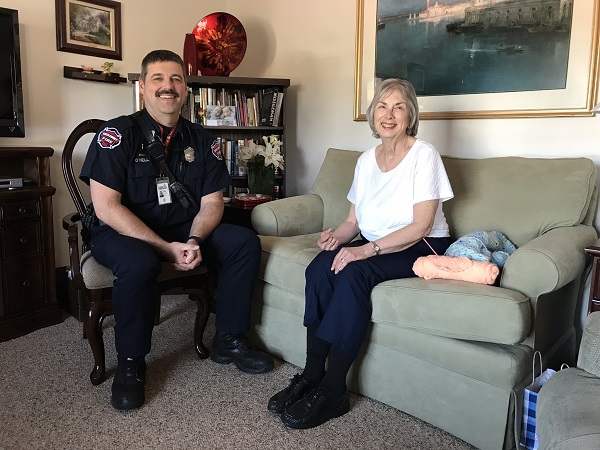 community paramedic sits with woman in a home