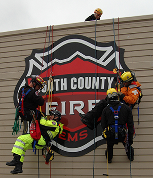 Rescue team rappelling at training tower